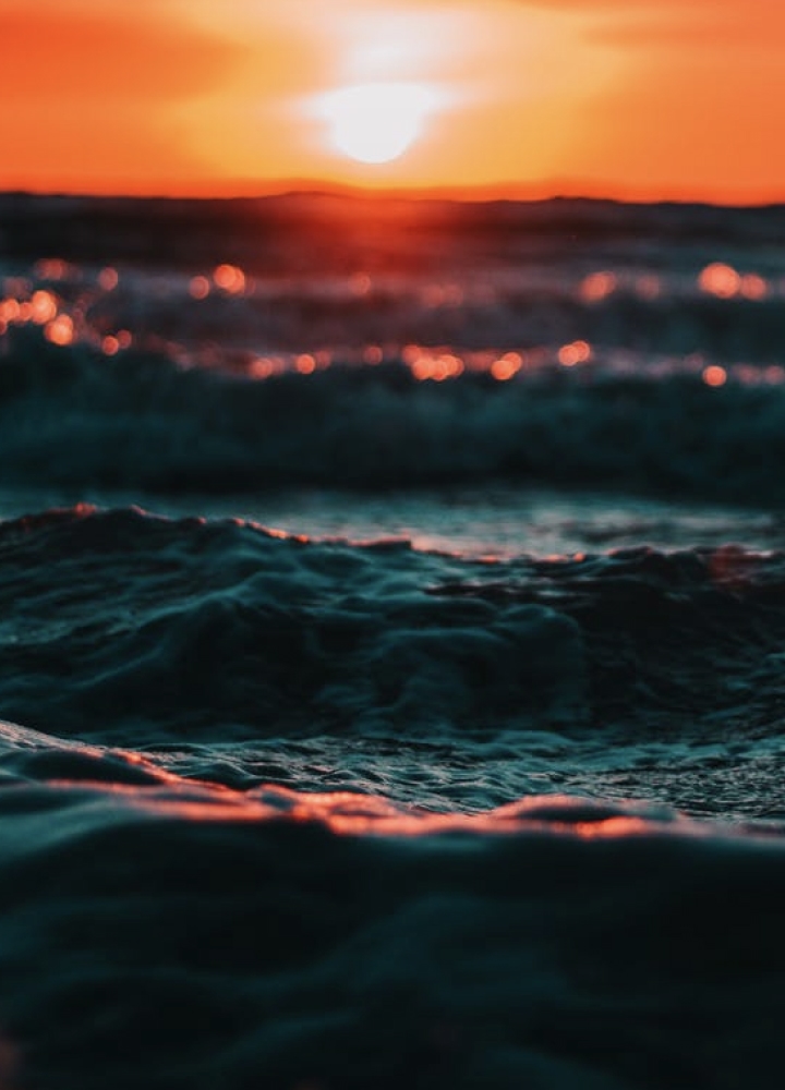 Close up of waves in the sea at sunset.